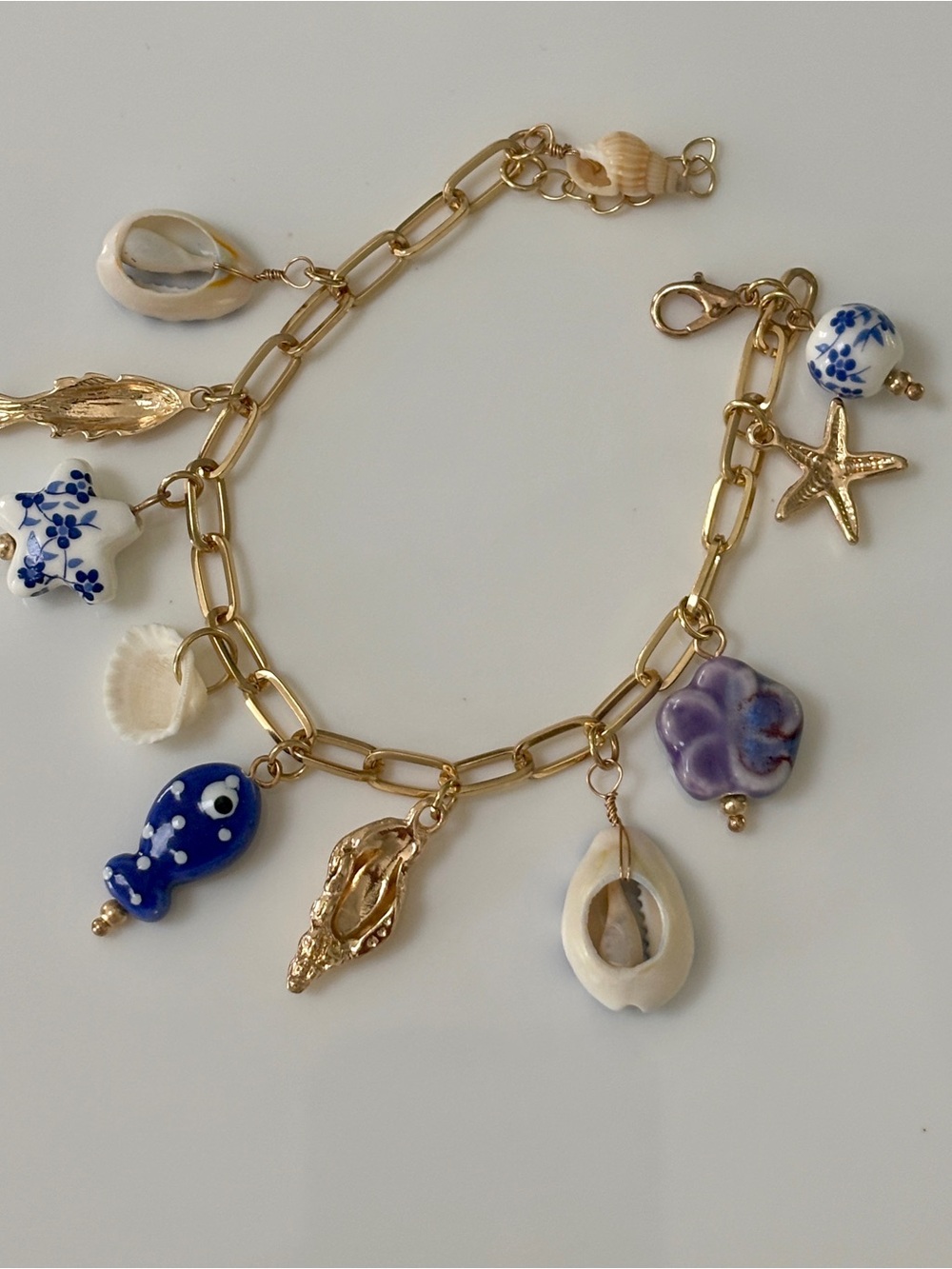 Blue Ocean Gold Charm Bracelet with Blue, White & Purple Shell Charms
